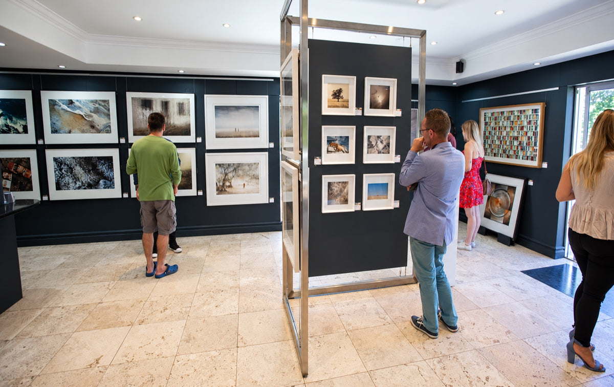Visitors looking at framed photographs inside Osner Gallery in Hout Bay