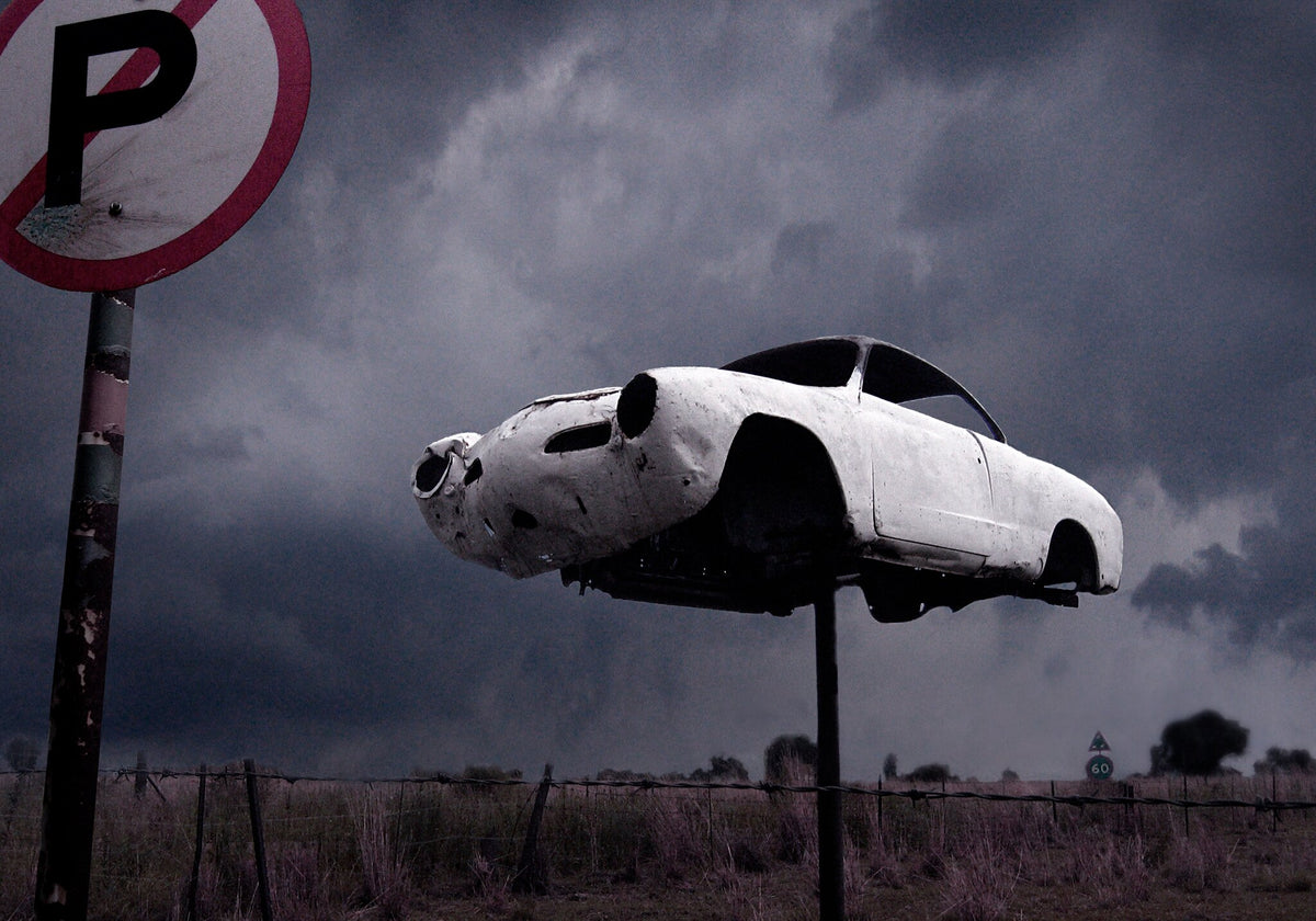 Abandoned No.1 by Martin Osner, a Karmann Ghia on a pole behind a no parking sign