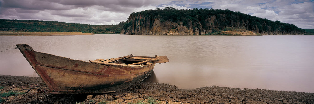 Boat on Massingir by Koos van der Lende, an old wooden boat on the Massingir Dam shore